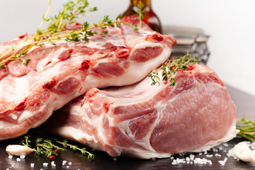 The carcass of a pig is divided into parts, an edge, a fillet, a scapula, a neck, a notch, a ham, a ham, a back. With spices, marasm. honest, pepper and salt. Raw pork meat. background image.