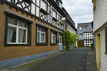 old small German town on the river bank narrow streets, pavement flowers on the windows