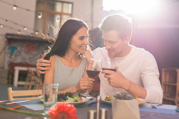 Romantic dinner. Stylish appealing woman feeling simply amazing while having romantic dinner with her loving man