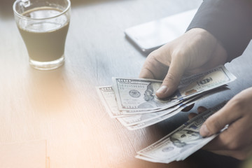 The white young Light toning Businessman counts the money, one hundred dollar