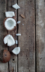 Ripe half cut coconut on a wooden background