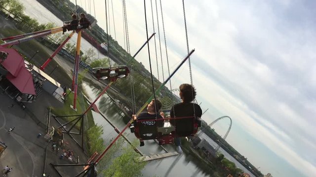 Riding a rotating gondola chair at amusement park.