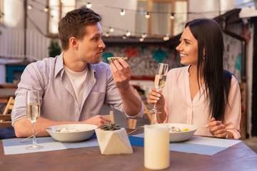 Smiling woman. Smiling beaming woman talking to her handsome husband during nice romantic dinner