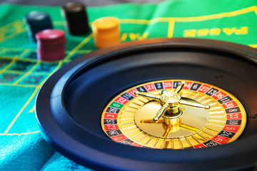Casino playing roulette on green table
