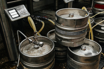 Many metal kegs of beer in beer plant. Bottling beer. Kegs upon kegs at a brewery