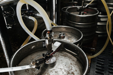 Many metal kegs of beer in beer plant. Bottling beer. Kegs upon kegs at a brewery - 212877622