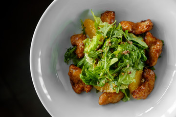  salad with chicken steak, salad mix, orange, cheese. Under the olive oil.