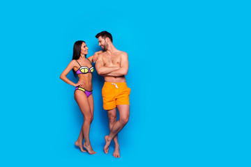 Full-length shot with handsome man and tender young woman in a separate swimsuit happy look into...