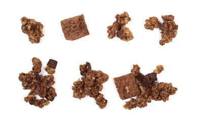 Crunchy chocolate granola, muesli pile isolated on white background, top view