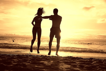 silhouette in love sunset sea / newlyweds in honeymoon at sea, vacation luck summer sea beach, silhouette couple at sunset