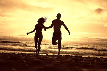 silhouette in love sunset sea / newlyweds in honeymoon at sea, vacation luck summer sea beach, silhouette couple at sunset