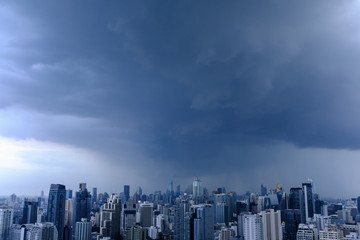 rain clouds over city, aerial cityscape, residential buildings and business skyscraper