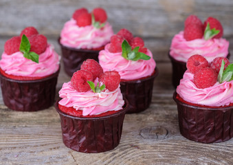 homemade cupcakes with pink cream and raspberry