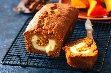 Freshly baked pumpkin pound cake with cream cheese filling served on a wire rack