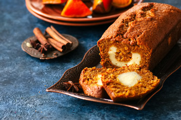 Freshly baked pumpkin pound cake with cream cheese filling served on a wire rack