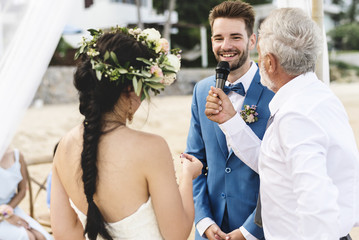 Young couple in a wedding ceremony at the beach