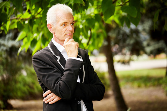 Portrait Of Old Bussines Man In Black Jacket. Look Around. Planing New Strategy