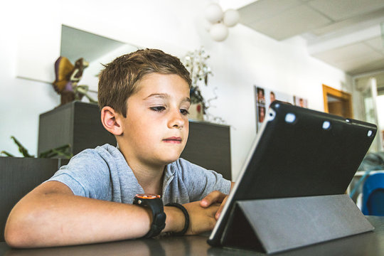 Child Watching A Tablet At Home