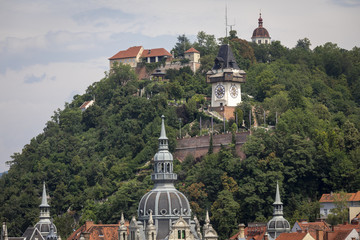Fototapeta na wymiar roofscape city of graz with schlossberg hill and clocktower, austria