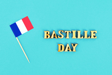 French flag on a blue background. The concept of the holiday is July 14, the Day of the Bastille.