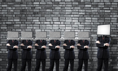 Businessmen with digital devices against head.