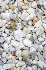 This is a crushed white stone background. White crushed stone. Gravel coating tracks.
