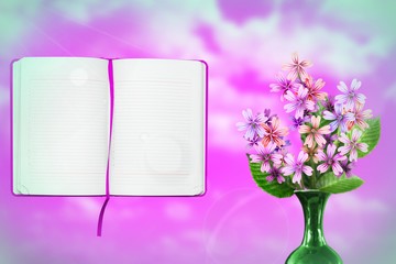 Beautiful live malva or mallow bouquet bouquet in ceramic vase with opened note book with blank place for your information on left on cloudy sky background.