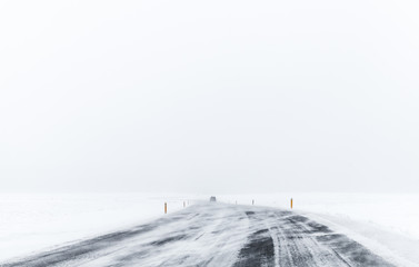 Lonely car on frozen road covered with snow