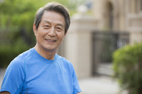 Portrait of senior man standing outdoors