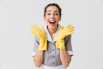 Portrait of an excited young housemaid dressed in uniform