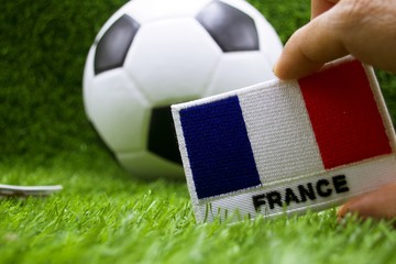 France flag and football is on green grass 