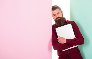 Fed up with creativity. Man bearded hipster worker with laptop lean on wall. Guy web developer programmer or designer. Common thought designers are hipsters. Why so many graphic designers hipsters