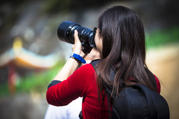 Young girl in midst of photography action with professional looking dslr