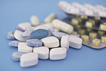 Supplements and medications, a pill bottle and blister packs, close-up