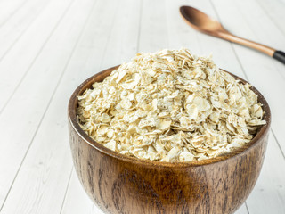 Grits in a wooden bowl on a light background