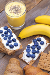 Obraz na płótnie Canvas Flat lay banana smoothie and crunchy croissants.