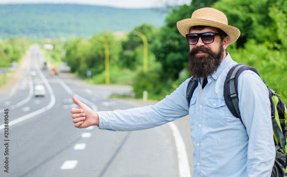 Wall mural Man try stop car thumb up. Pick me up. Hitchhiking one of cheapest ways traveling. Picking up hitchhikers. Hitchhikers risk being picked up by someone who is unsafe driver or personally dangerous