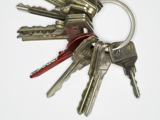 Close-up of a keyring on white background witha red key