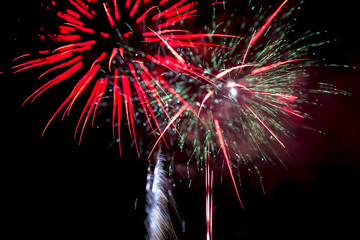 Night burst of beautiful firework celebration with colorful glow, glitter, pattern and motion