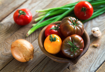 Home-grown various tomatoes on vintage wooden boards.