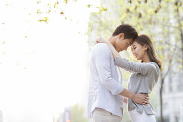 Side view of happy young couple dancing outdoors