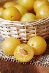 Yellow cherry plums also known as mirabelle plums in woven basket