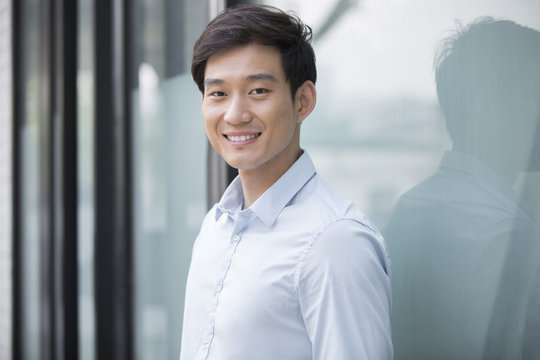 Portrait of cheerful young Chinese businessman