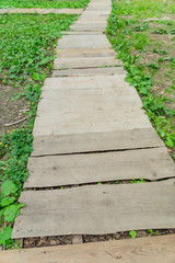 wooden path over meadow in the countryside