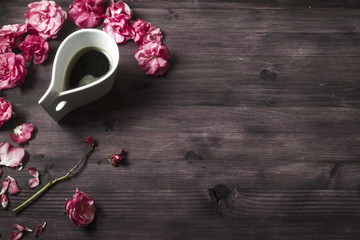 Cup of coffee espresso wirh pink flowers around the cup