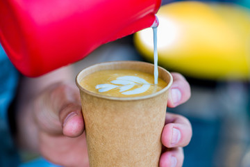 barista makes coffee to go
