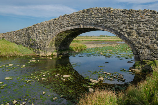 The arched Aberffraw Bridge in Anglesey