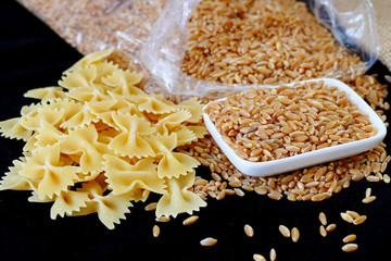 pasta and wheat together on a black background

