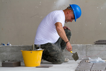 bricklayer at work in building site