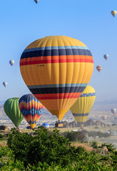Goreme, Cappadocia, Turkey - 10 June, 2018: view of colorful hot air balloons flying over the Red valley on sunrise